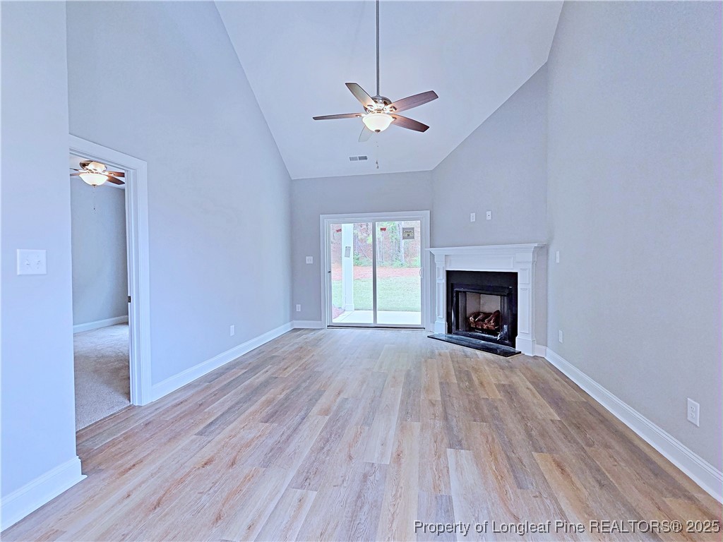 940 Kensington Park Road Fayetteville, NC 28311 - Photo 3 of 41 a view of an empty room with wooden floor fireplace and a window