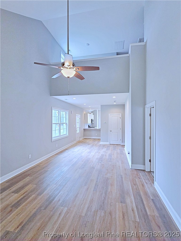 940 Kensington Park Road Fayetteville, NC 28311 - Photo 6 of 41 a view of an empty room with a window and wooden floor