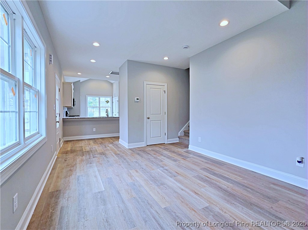 940 Kensington Park Road Fayetteville, NC 28311 - Photo 6 of 38 a view of an empty room with wooden floor and a window