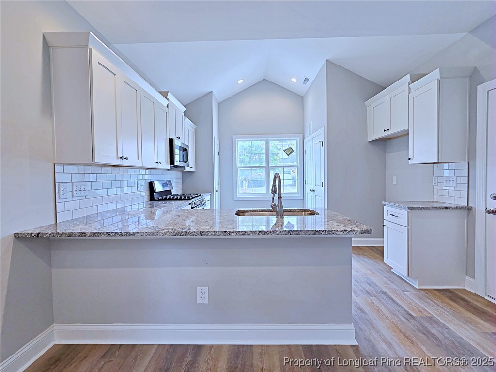 940 Kensington Park Road Fayetteville, NC 28311 - Photo 9 of 38 a kitchen with stainless steel appliances granite countertop a sink stove and refrigerator