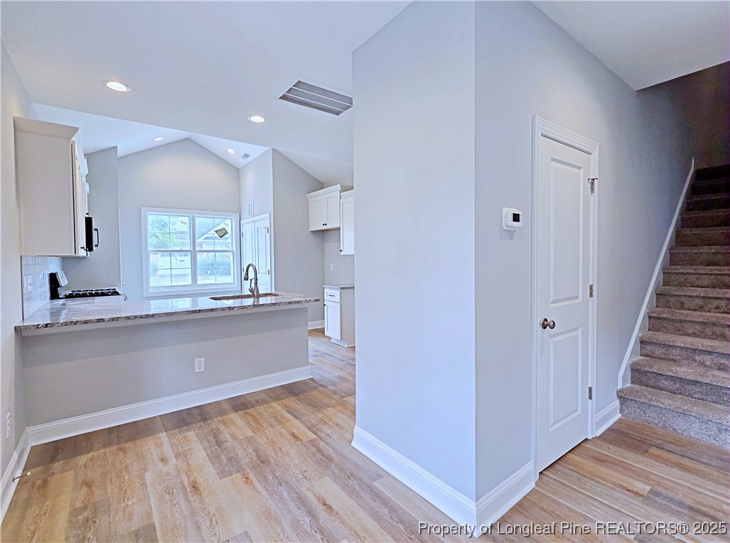 940 Kensington Park Road Fayetteville, NC 28311 - Photo 9 of 41 a large white kitchen with wooden floors and white walls
