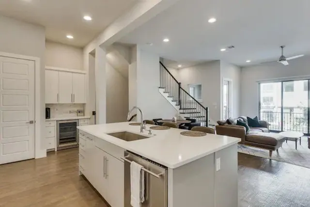 a kitchen with sink stove and chairs