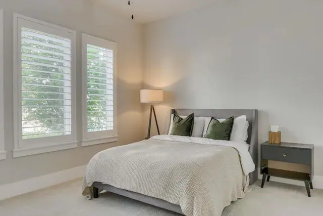 a bed sitting in a bedroom next to a window