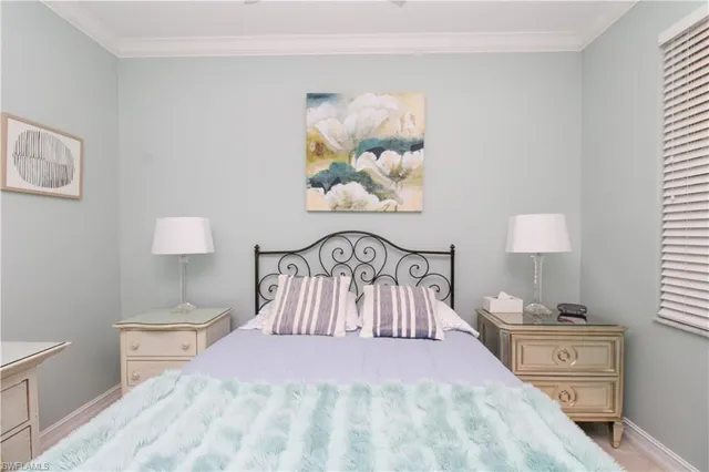 a bedroom with a bed and a painting on the wall