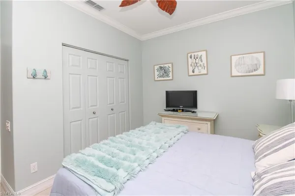 a bedroom with a bed and a flat screen tv