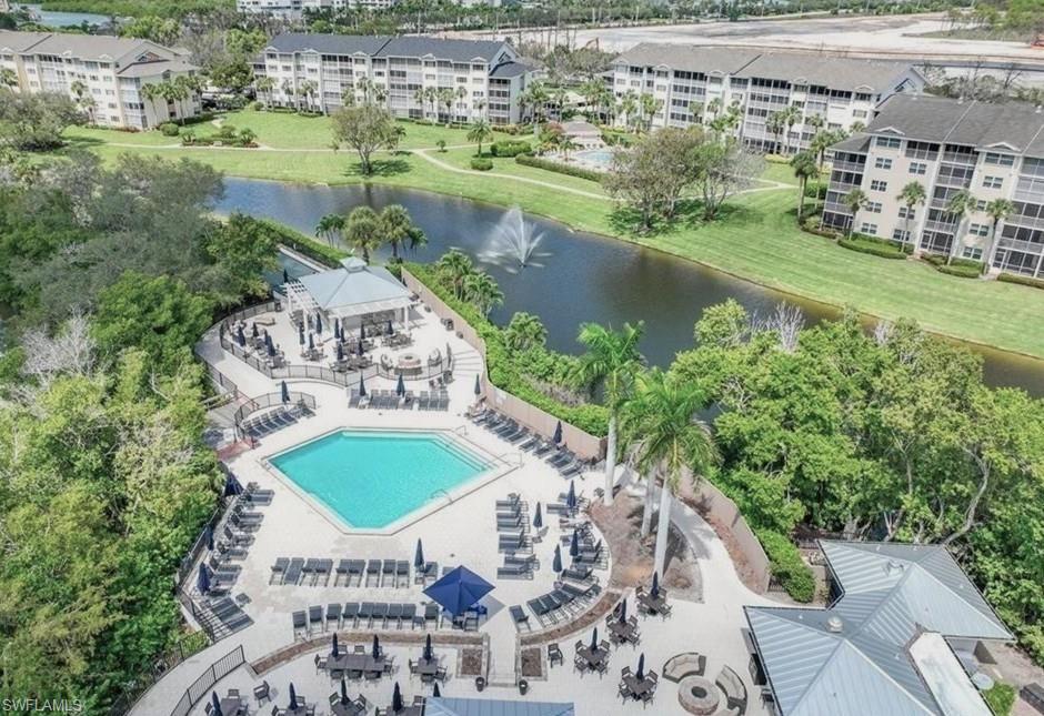 817 Carrick Bend Circle, Unit 101 Naples, FL 34110 - Photo 2 of 49 a view of a lake with a yard