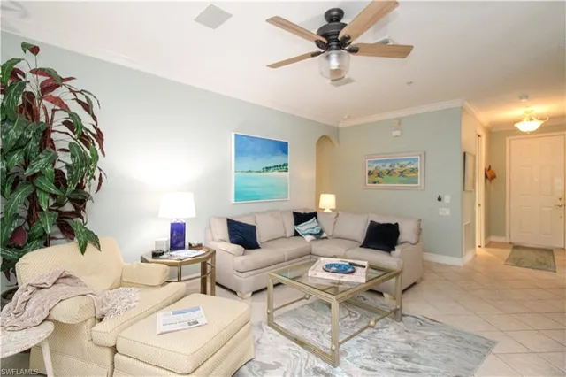 a living room with furniture and a chandelier