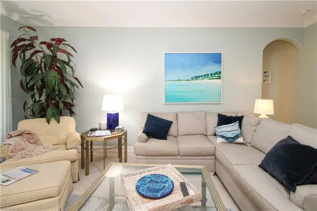 a living room with furniture and a lamp