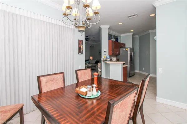 a dining room with furniture and a chandelier