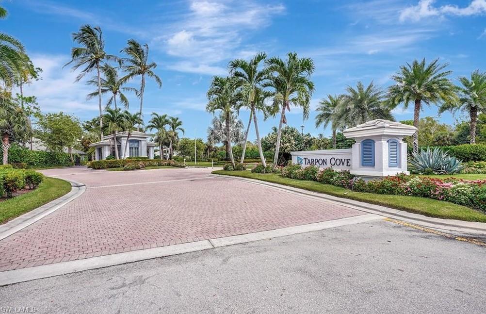 817 Carrick Bend Circle, Unit 101 Naples, FL 34110 - Photo 3 of 49 a view of a house with palm trees and a small yard