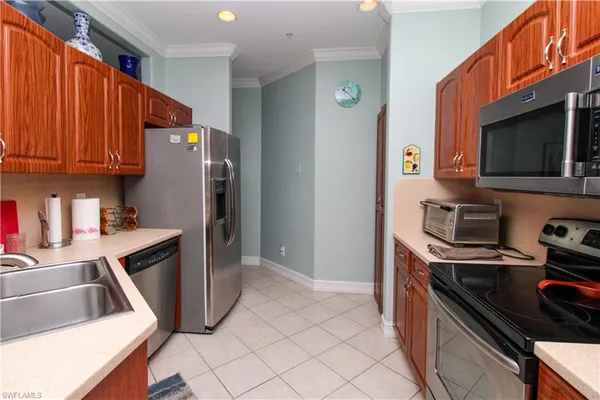 a kitchen with a sink stove and refrigerator