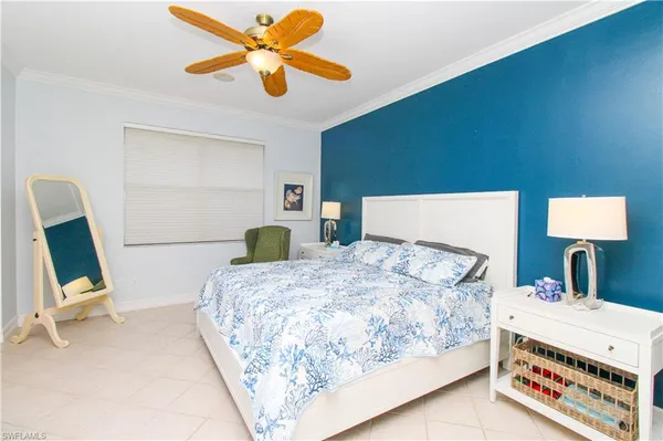 a bedroom with a bed a desk and chair