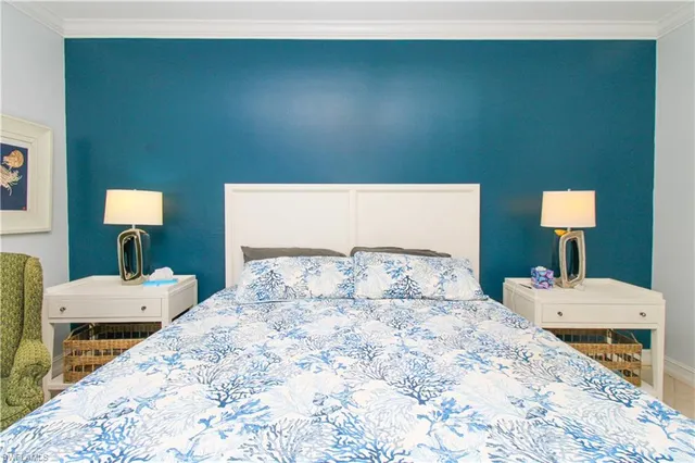 a bedroom with a bed and a lamp