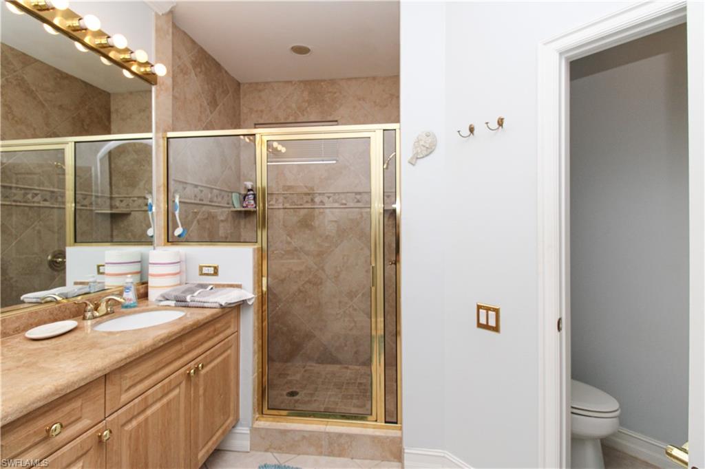 817 Carrick Bend Circle, Unit 101 Naples, FL 34110 - Photo 41 of 49 a bathroom with a sink and a mirror