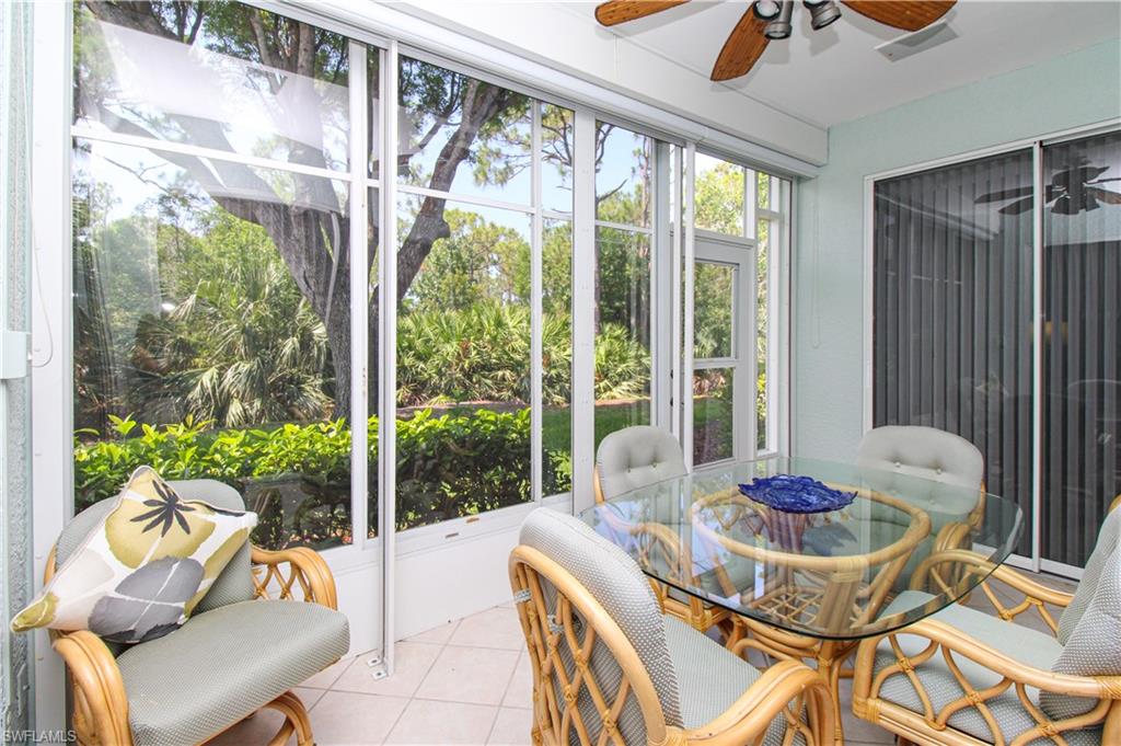 817 Carrick Bend Circle, Unit 101 Naples, FL 34110 - Photo 47 of 49 a dining room with furniture and large windows