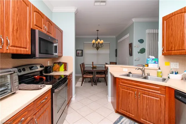 a kitchen filled counter top space a sink cabinets and appliances