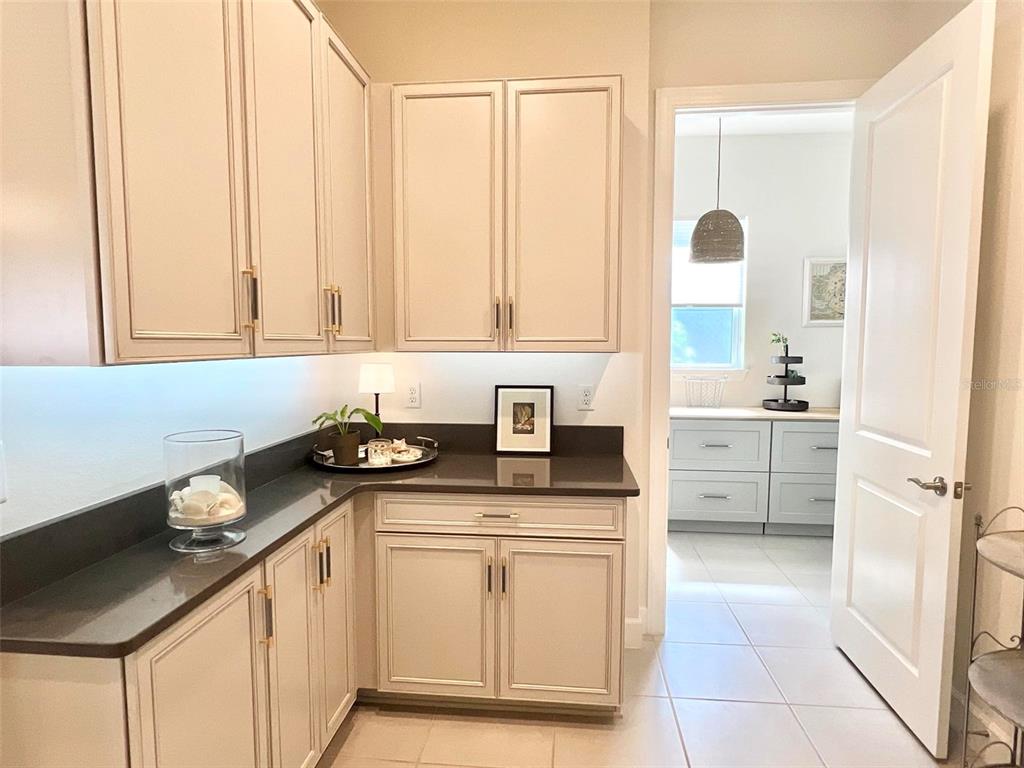 2337 Clemblue Road Clermont, FL 34715 - Photo 11 of 33 a kitchen with granite countertop a sink stove and cabinets