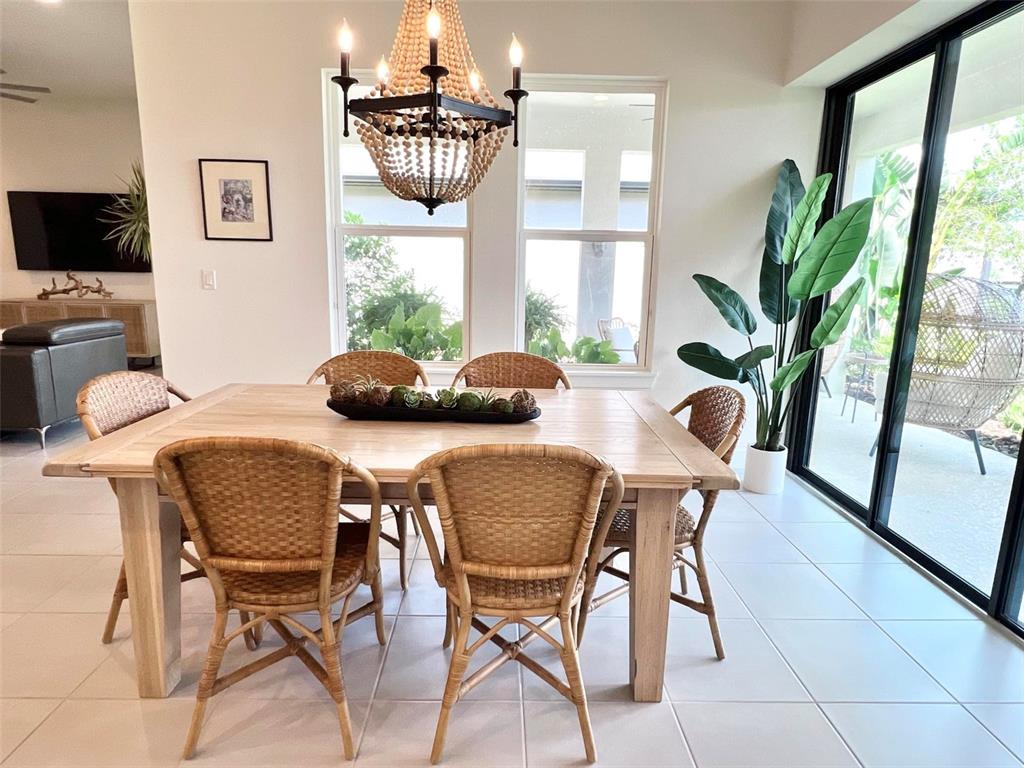2337 Clemblue Road Clermont, FL 34715 - Photo 15 of 33 a dining room with furniture and large windows