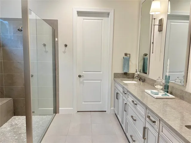 a bathroom with a double vanity sink and a mirror
