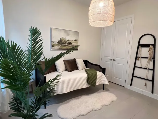 a bedroom with a bed and a chandelier