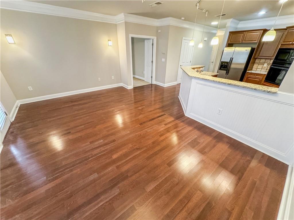 2000 Sterling Court Roswell, GA 30075 - Photo 17 of 45 a view of kitchen and empty room with wooden floor