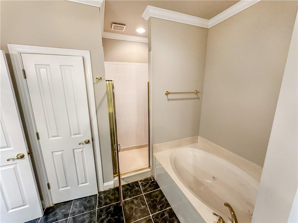 2000 Sterling Court Roswell, GA 30075 - Photo 22 of 45 a bathroom with a bathtub and a shower
