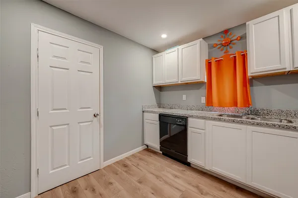 a kitchen with stainless steel appliances granite countertop a sink and cabinets