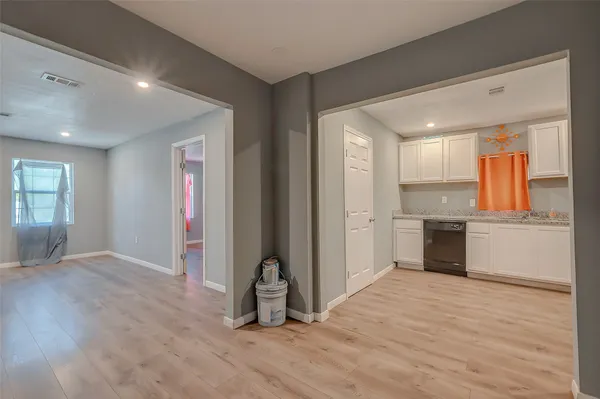 a view of a kitchen with a sink and dishwasher wooden floor