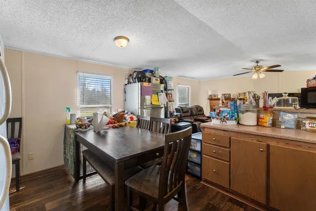 a kitchen that has a lot of cabinets a sink and appliances