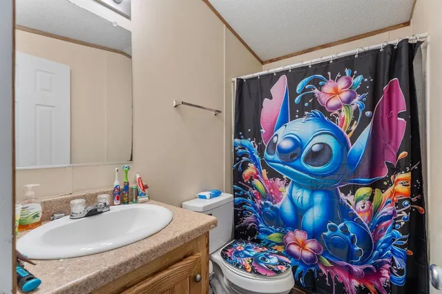 a bedroom with bed and a flat screen tv