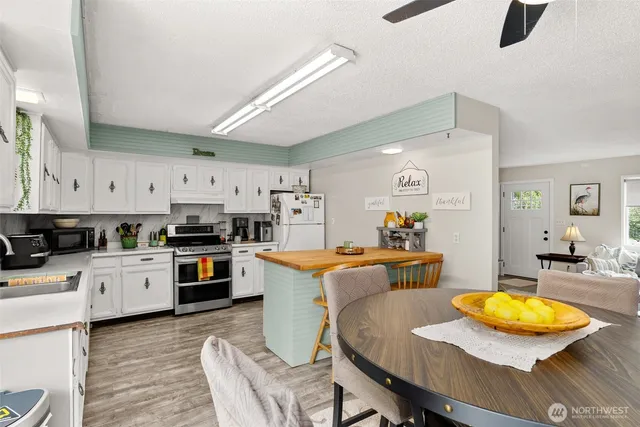 a kitchen with stainless steel appliances kitchen island granite countertop a sink and cabinets