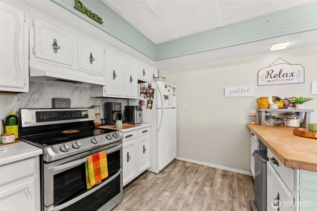 a kitchen with stainless steel appliances a stove a microwave and a refrigerator