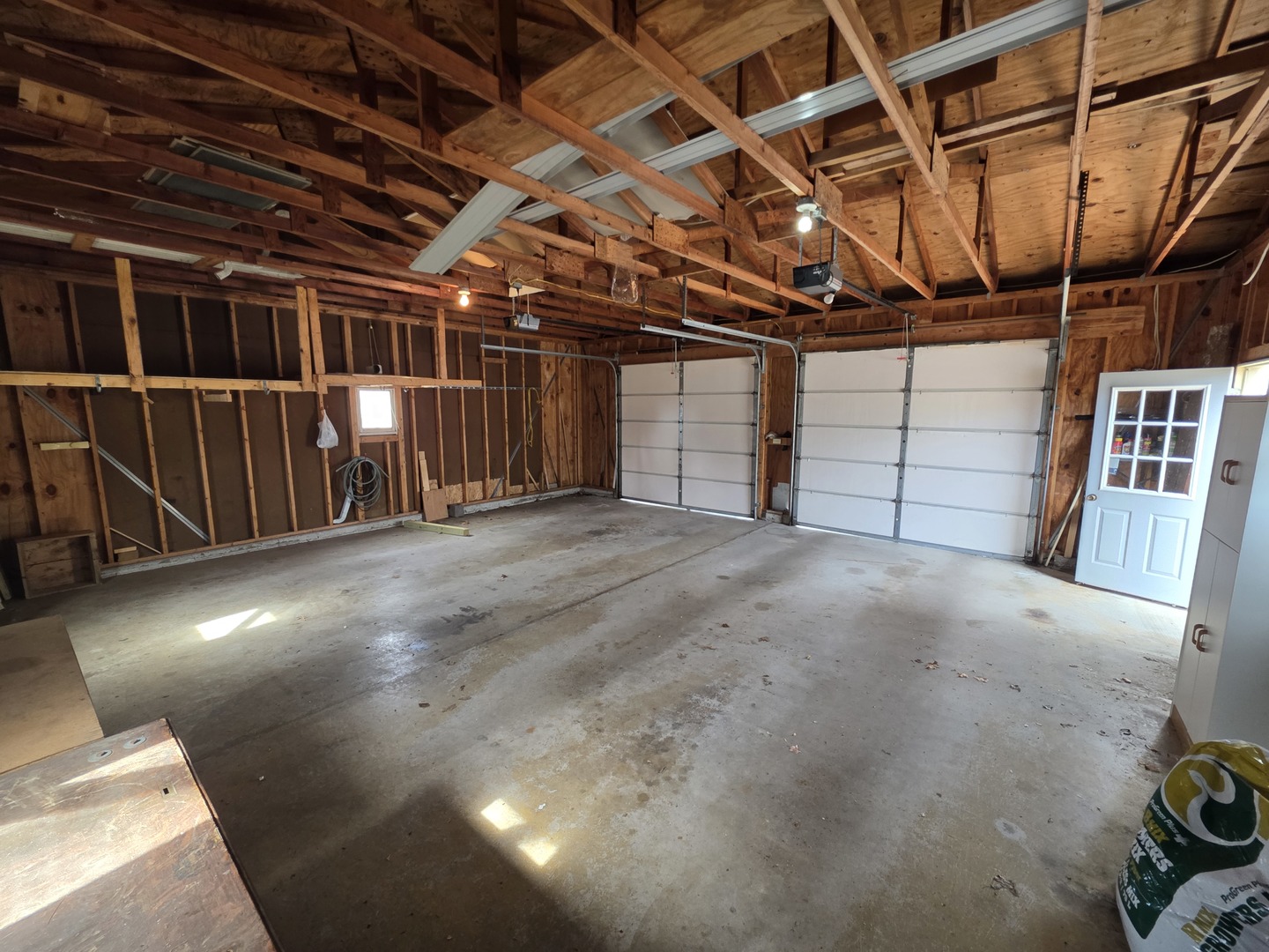 209 West Grove Road Sterling, IL 61081 - Photo 8 of 35 a view of an empty room with wooden walls