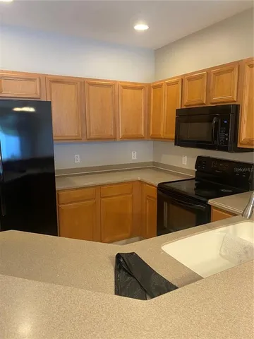 a kitchen with a sink a stove and cabinets