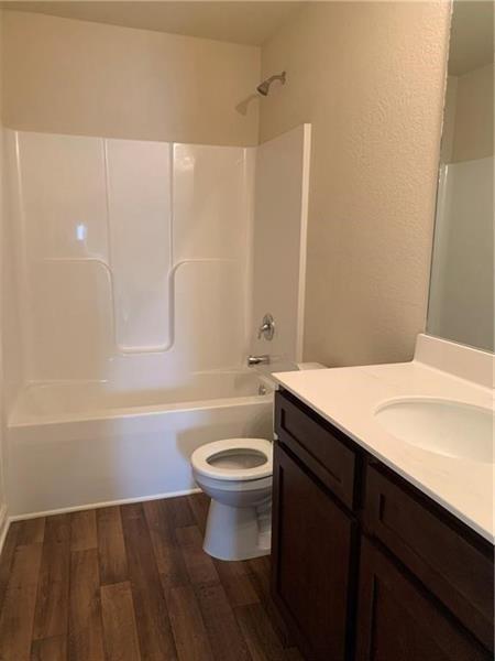 960 Walnut Creek Circle Pendergrass, GA 30567 - Photo 5 of 9 a bathroom with a sink a toilet a mirror and bathtub
