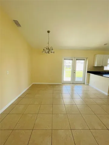 a view of an empty room and a bathroom