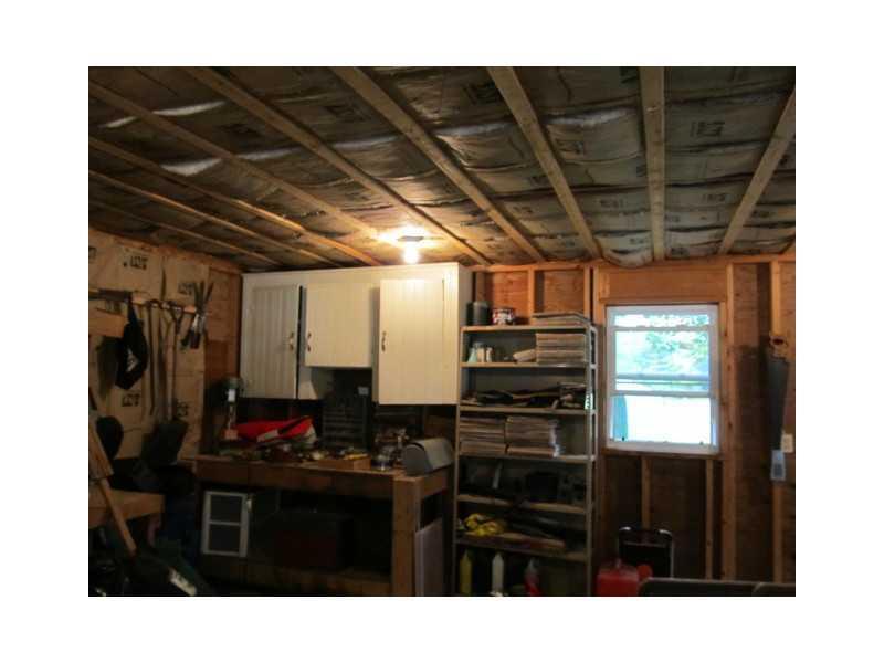 72 W Road West Gardiner, ME 04345 - Photo 22 of 26 Garage. Garage with work benches and...