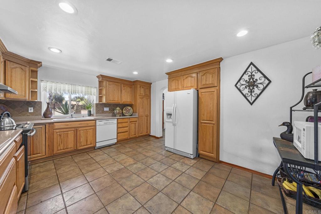 30265 Miller Road Valley Center, CA 92082 - Photo 10 of 56 a kitchen with a refrigerator and a sink