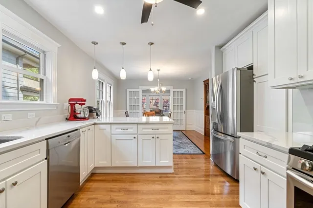 a large kitchen with cabinets and stainless steel appliances