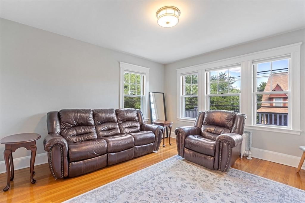 1045 Adams Street, Unit 1 Boston, MA 02124 - Photo 12 of 30 a living room with furniture and a window