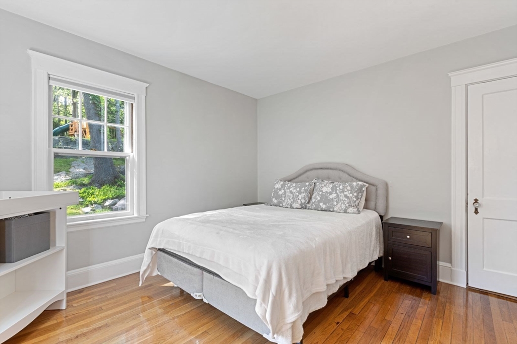 1045 Adams Street, Unit 1 Boston, MA 02124 - Photo 15 of 30 a bedroom with a bed and a window