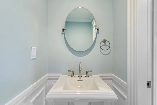 a view of an empty room with wooden floor and a ceiling fan