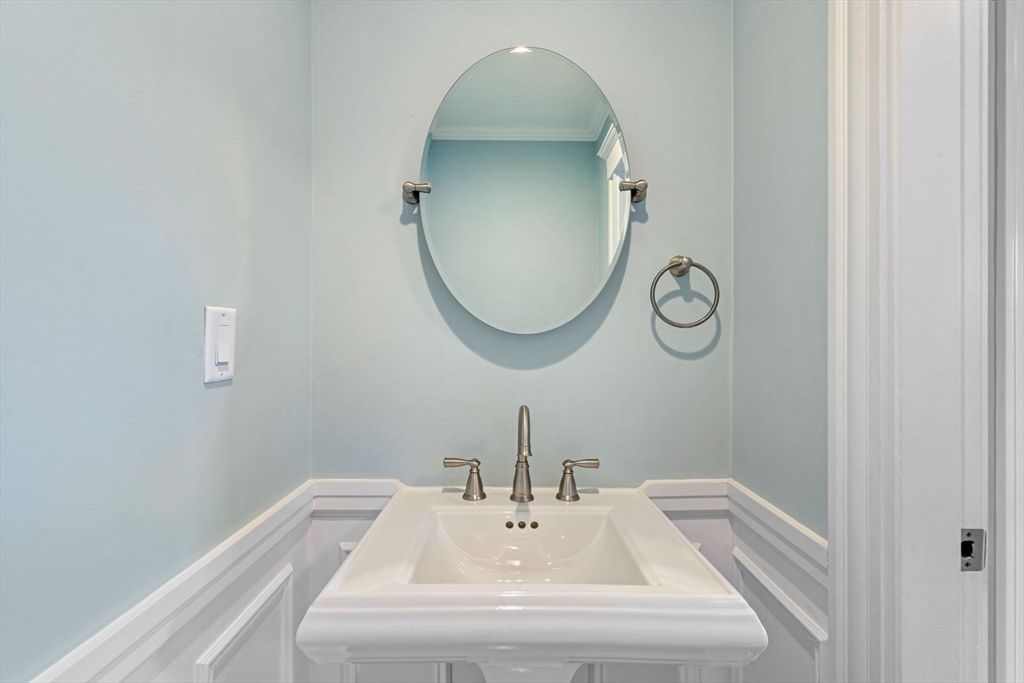 1045 Adams Street, Unit 1 Boston, MA 02124 - Photo 19 of 30 a bathroom with a sink and a mirror