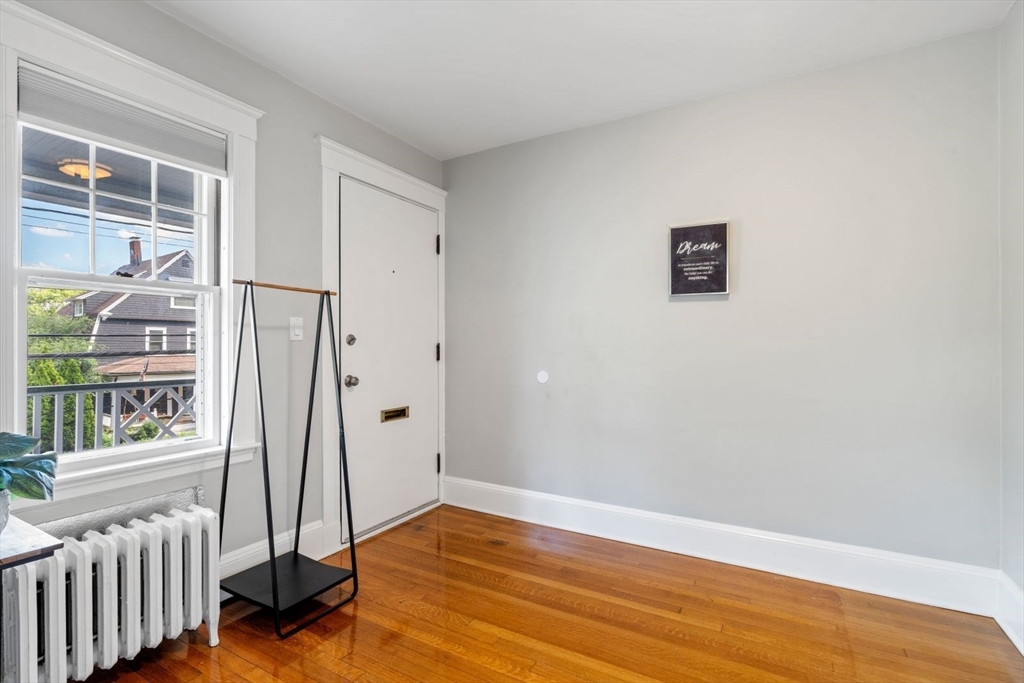1045 Adams Street, Unit 1 Boston, MA 02124 - Photo 21 of 30 a view of livingroom with hardwood floor and window
