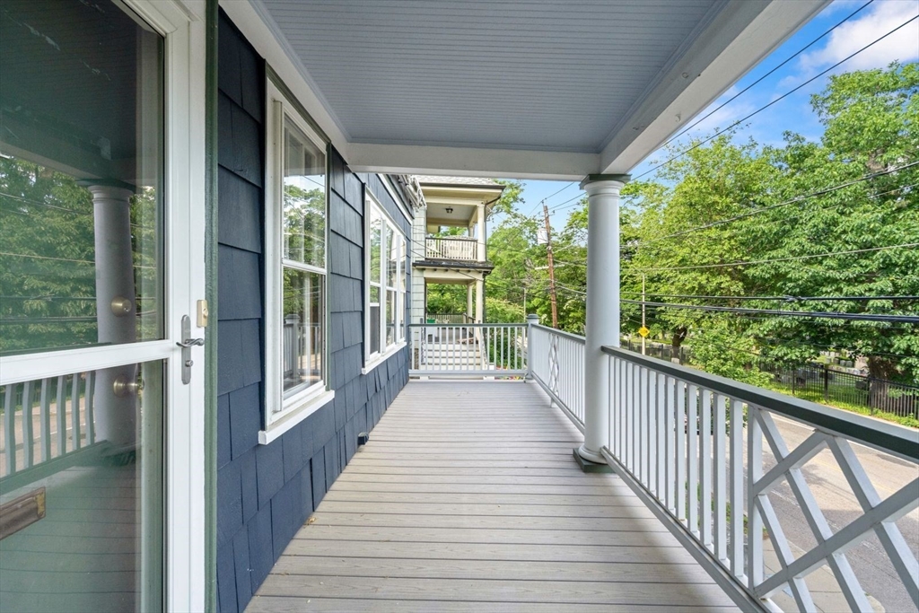1045 Adams Street, Unit 1 Boston, MA 02124 - Photo 24 of 30 a view of a balcony with wooden floor