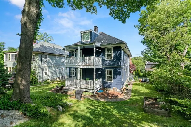 a front view of a house with a yard table and chairs