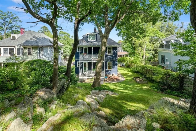 a view of backyard of house with green space