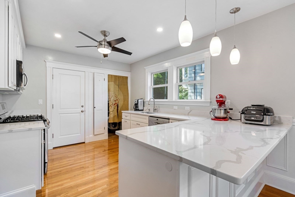 1045 Adams Street, Unit 1 Boston, MA 02124 - Photo 3 of 30 a kitchen with sink refrigerator and window