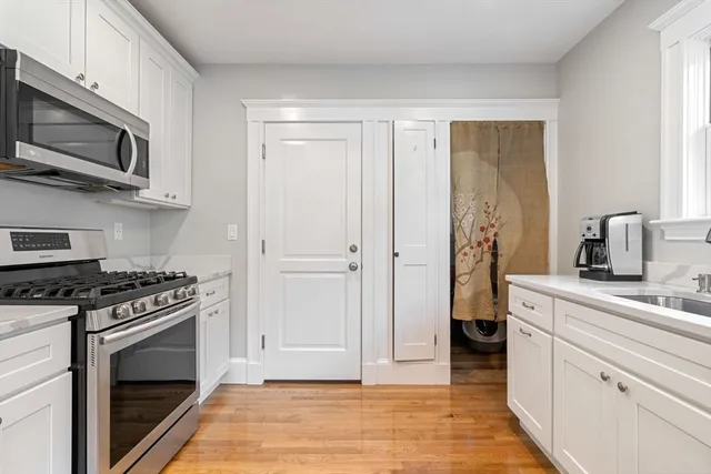 a kitchen with stainless steel appliances a stove a microwave and cabinets