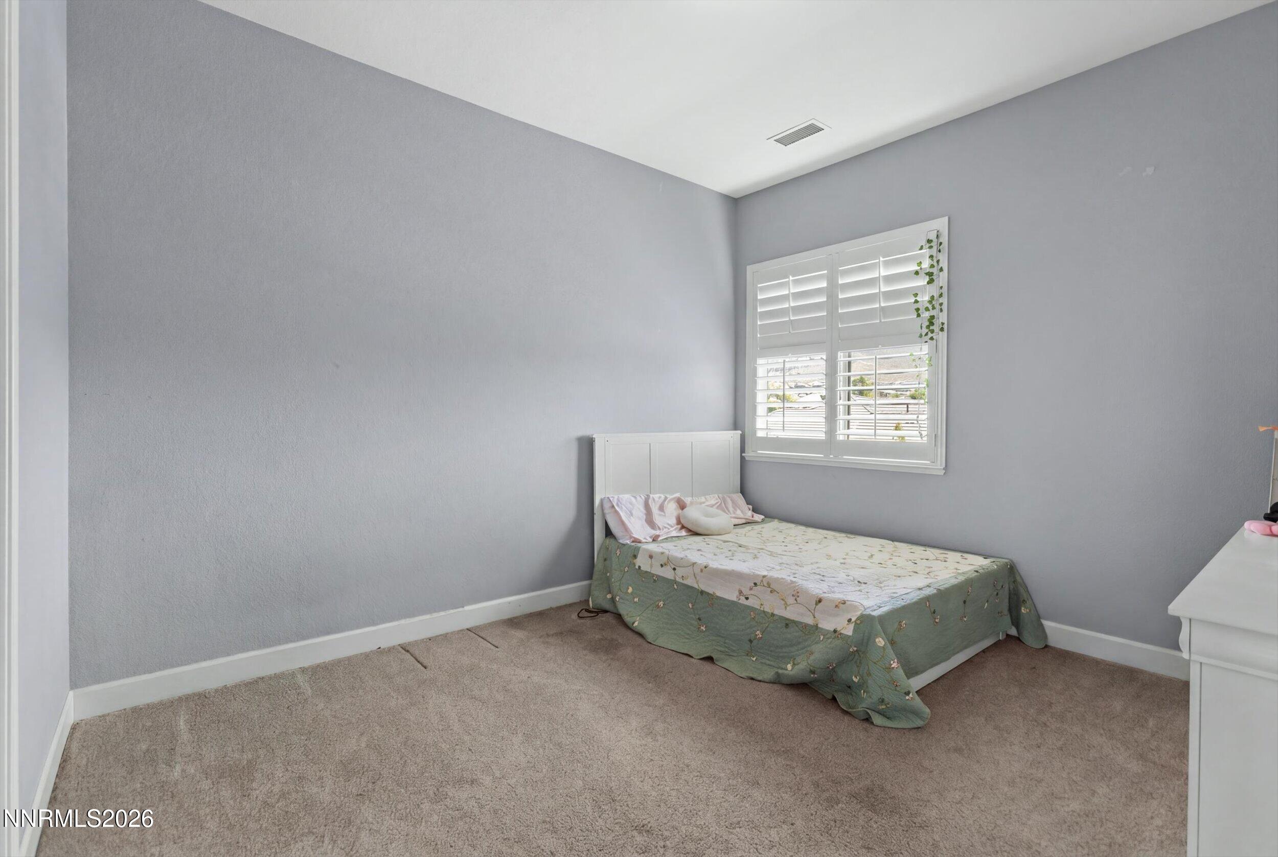 2920 Bull Rider Drive Reno, NV 89521 - Photo 27 of 51 a bedroom with a bed and window